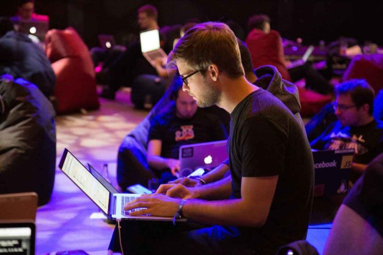 Foto de um homem sentado usando um laptop